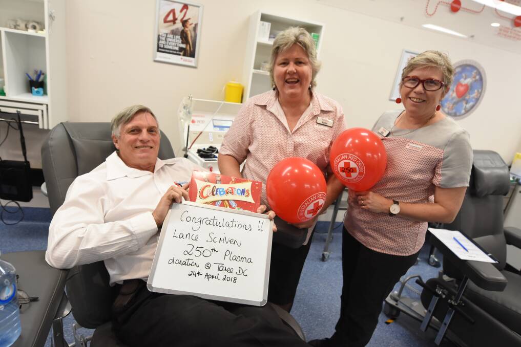 Lance Scriven, pictured with Taree Blood Bank's Kellie Harrison and Ange Callaghan, giving his 250th blood donation earlier this year. Photo: Scott Calvin.