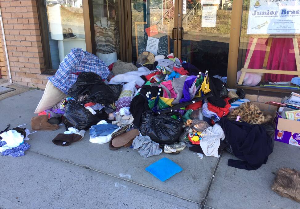 What a mess: Books, clothes and shoes were among the items dumped outside of the Taree Salvation Army Family store earlier this week. Photo: Toni Bell. 