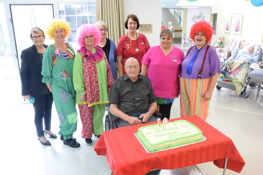 Happy Birthday: Resident Bill Bartlett cut the cake alongside Sharyn Speakman, Linda Stamp, Lorraine Fawkner, Ashleigh Allen, Judith Smith, Kerry Eyb and Melissa Cornall. 