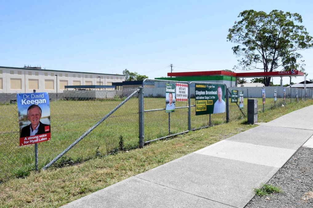 Is it too much?: Almost 20 election signs have been posted along a fence next to Taree Central. Photo: Scott Calvin.