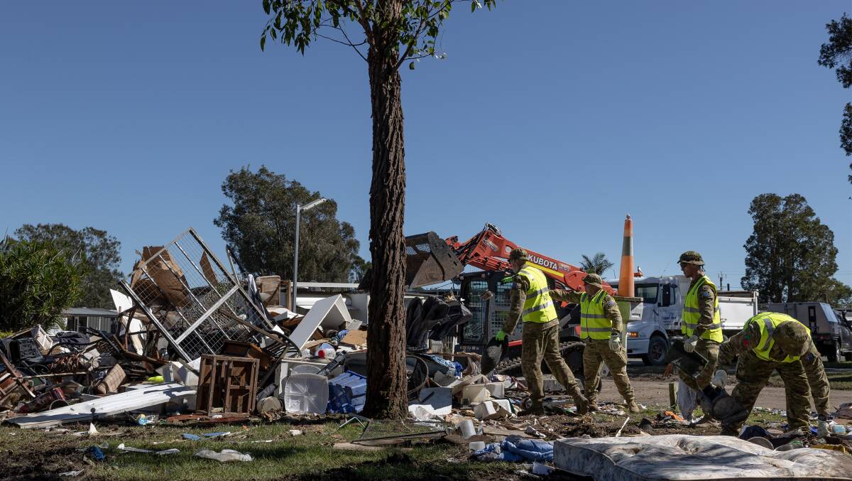 Australian Army Reservists from the 5th Engineer Regiment assist with clean-up efforts at Weeroona Holiday Park in Manning Point. Photo: LAC John Solomon.