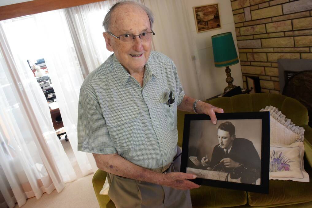 New Order of Australia Medal recipient Harvey Else with a photo of himself in his younger days. Photo: Rob Douglas.