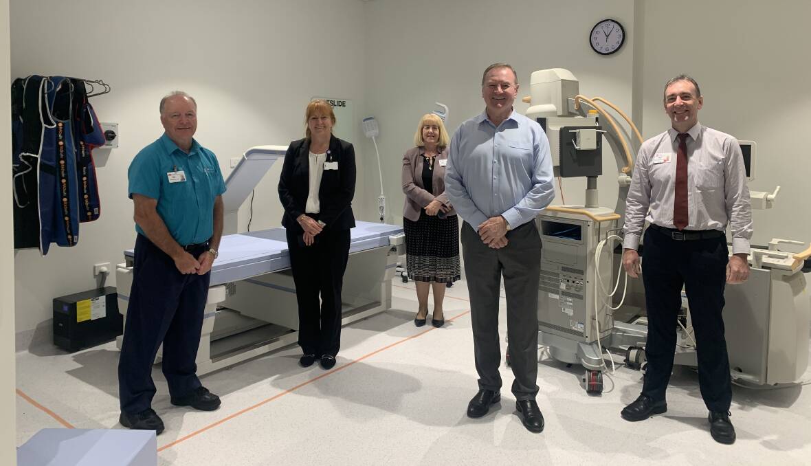Manning Base Hospital medical imaging chief radiographer Tony Burns, Manning Base Hospital general manager Jodi Nieass, Greater Metropolitan Health Services (GMHS) executive director Karen Kelly, Myall Lakes MP Stephen Bromhead and GMHS and Hunter New England Imaging chief radiographer Darrin Gray with the new bone density scanner. 