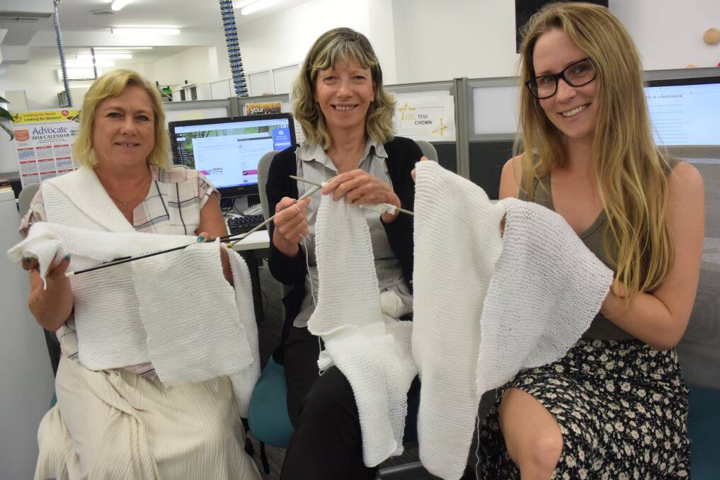 Hard at work: Manning River Times' Joanne Mansell, Tess Chown and Sally Codyre prepare their contribution for the White Ribbon initiative.