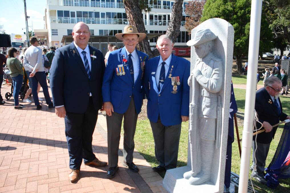 Club Taree chief executive Paul Allan with Taree RSL Sub-branch vice president Darcy Elbourne and president Charlie Fisher with the new statue at the Taree War Memorial. Photo: Scott Calvin.