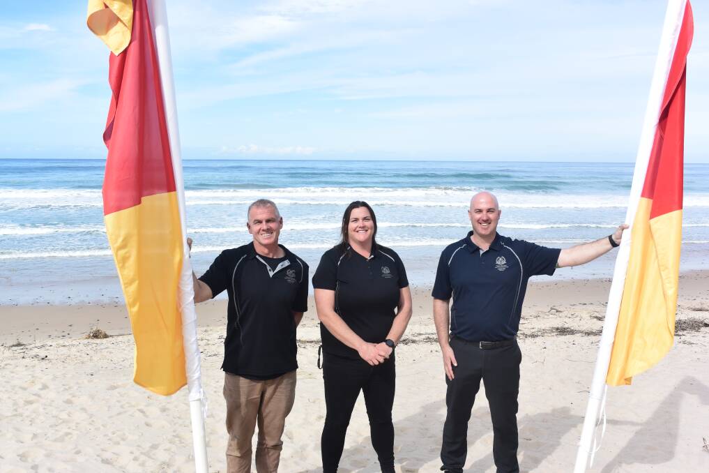 Between the flags: Taree Old Bar SLSC lifesaving director Dean Donovan, president Jane Lynch and finance director Michael Cameron are thrilled with progress at the club in recent times. Photo: Rob Douglas.