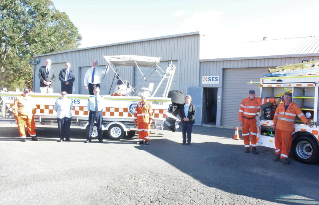 The Taree SES unit, pictured with Myall Lakes MP Stephen Bromhead and NSW Police Minister David Elliott, was thrilled with the new storm truck and punt.