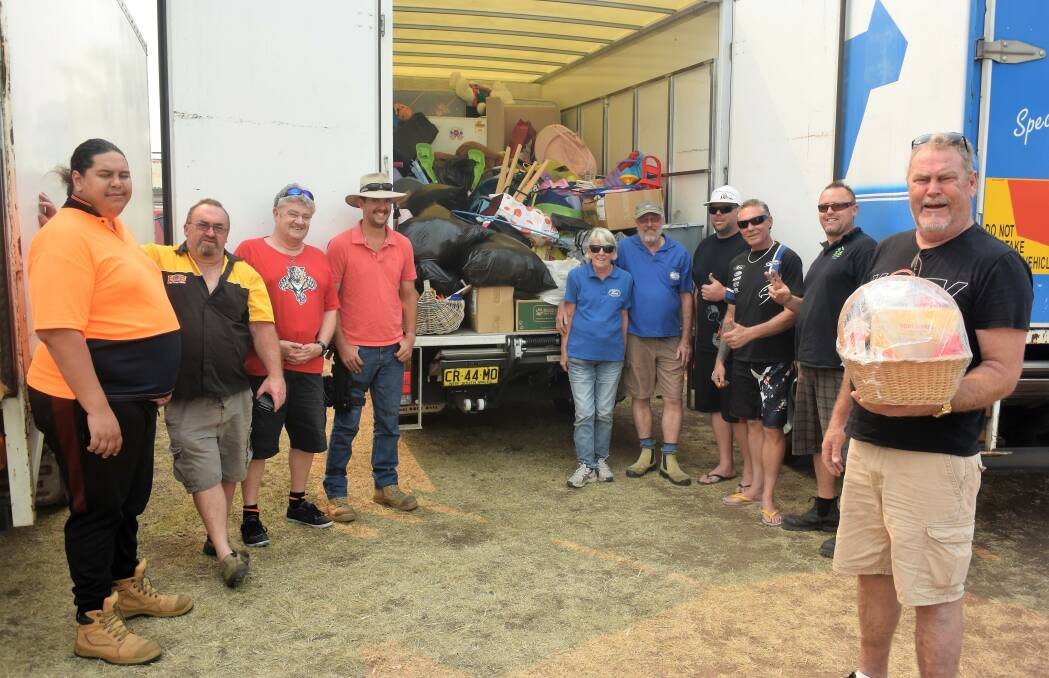The team from White Knight Limousines on the Central Coast delivered items to Taree Showground. Photo: Rob Douglas. 
