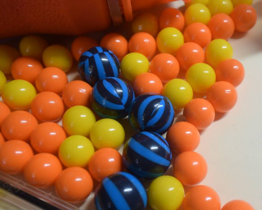 Fifity calibre paintballs (yellow and orange) are commonly used for beginners to the sport. Their size is compared to 68 calibre paintballs (black and blue). 