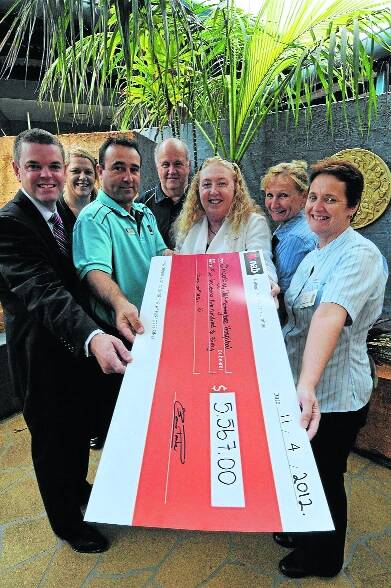 Happy occasion: At Manning Hospital for the presentation of the giant cheque were Justin Stack, Leanne Wood, Mark Kircher, Phil Shoesmith, Ros Everingham, Maureen Hogan and Fran Boad.
