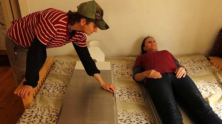Quality control ... Victoria Spence, above right, tries out one of the cooling beds which allow a body to be kept in the home for up to five days.