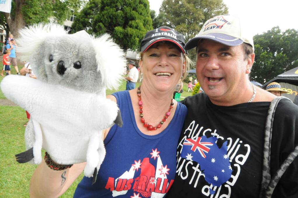 Glenys Fuller and Rob Green display their national pride at Taree's Australia Day celebrations last year. This year's Taree event will be held at the Manning Entertainment Centre.