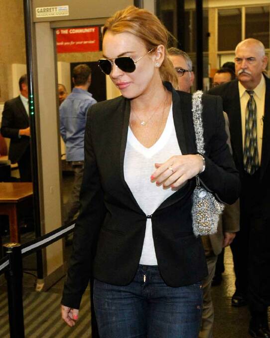 Lindsay Lohan tries to hide behind her Aviators - but the lips give the game away.