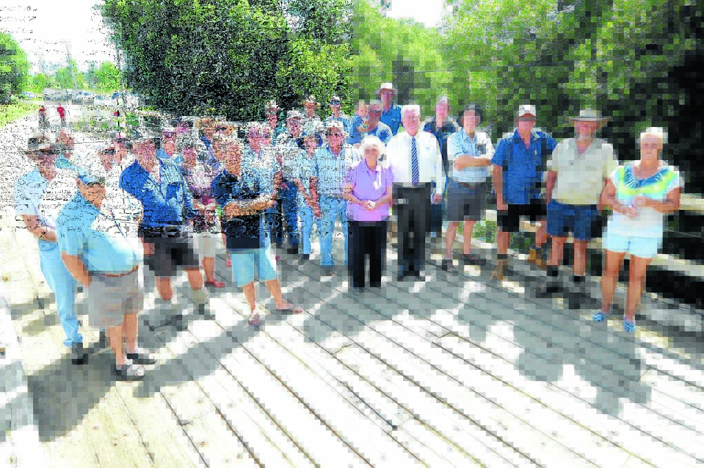 Greater Taree City Council mayor, Paul Hogan (fifth from right) stands with the community of people from the Moto area who want the federal government to reinstate funding to get Dickenson's Creek Bridge replaced.