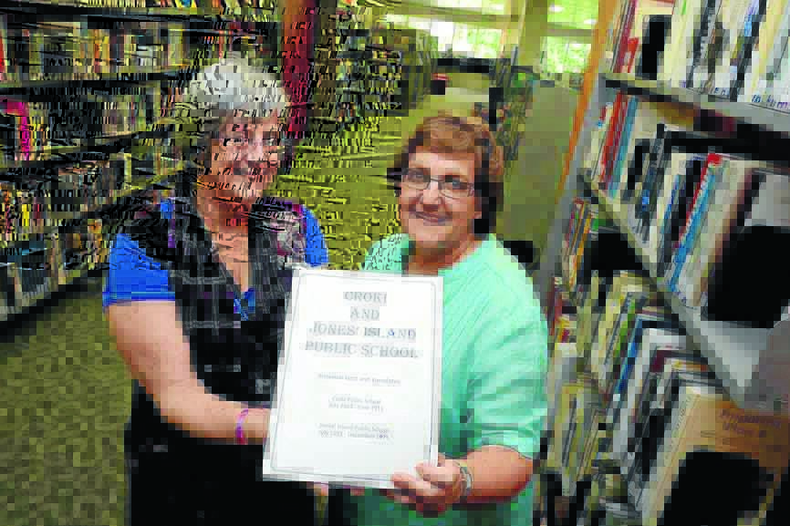 Anne Jones from Taree Library accepts the book, Croki and Jones Island Public School  Historical facts and anecdotes , from Barbara McClintock.