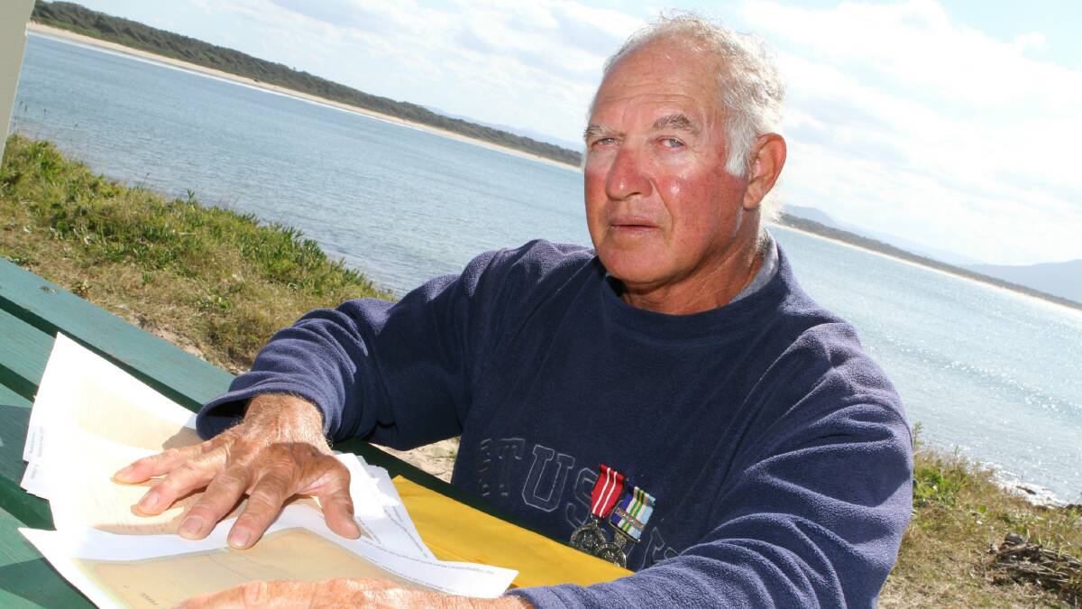 Ray Saunders with his great-uncle Harold Maher's war records. Carl Muxlow photo.
