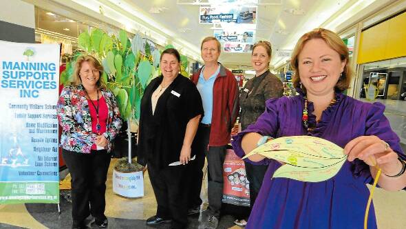 Shopping centre display: Nina Christian from Family and Community Services, Jo Gilkison and Peter Stace from Manning Support Services, Bree Dennis from Greater Taree City Council and Natasha Brotheron from Manning Support Services manning the Child Protection Week display yesterday at Taree City Centre