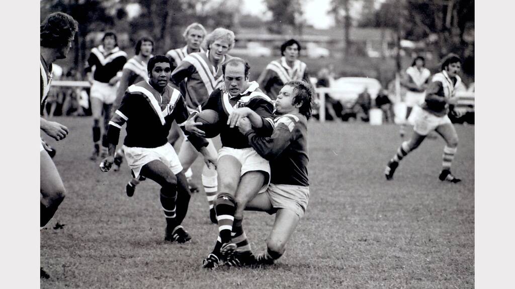 Paul Wilson stops and Eastern Suburbs ball carrier. Eric Ferguson from Easts along with Wayne Burgess and Rex MacKellar from United are in the background.