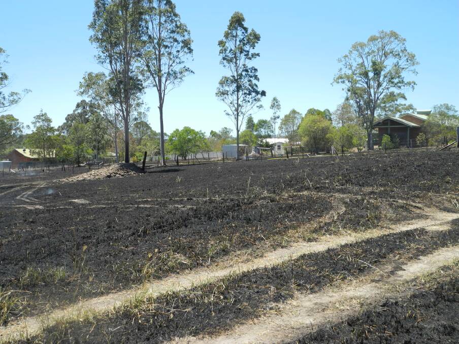 The blackened, smouldering landscape at Sunset Avenue after a fire raged out of control in Wingham.