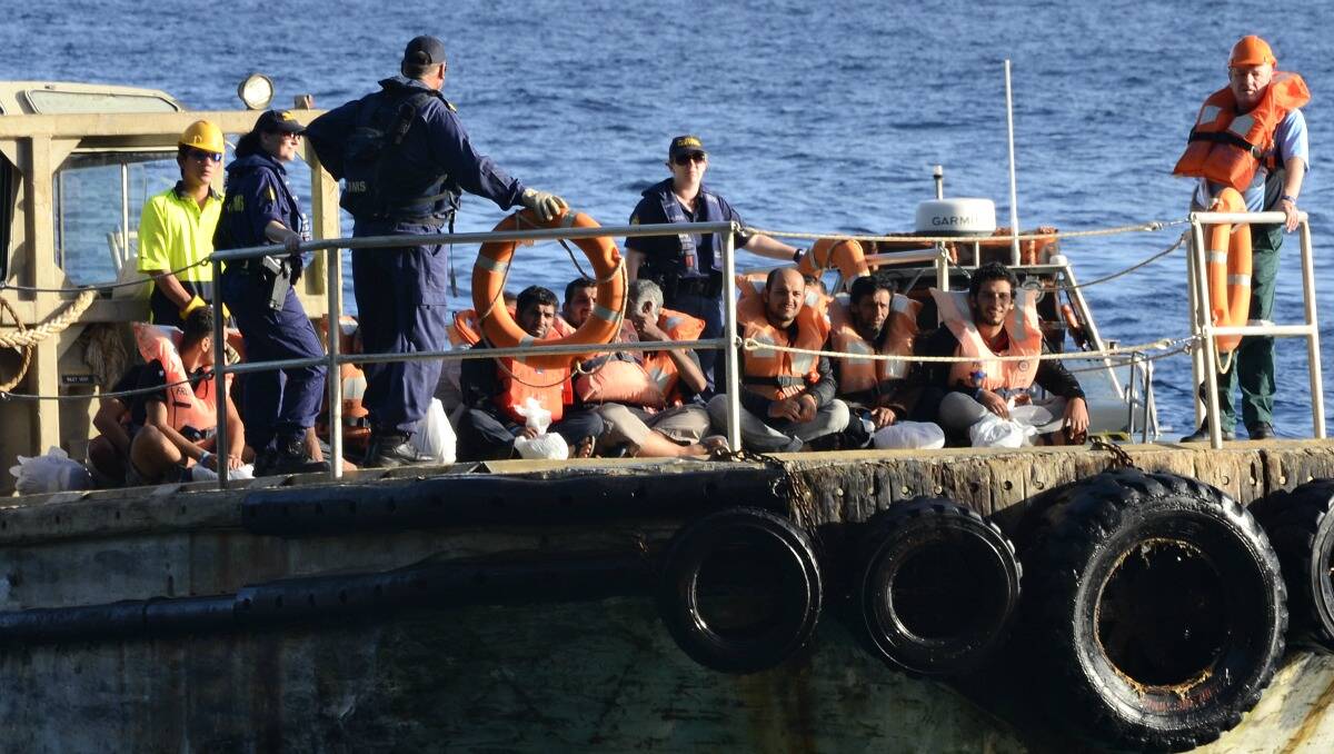 Refugees get taken ashore to Christmas Island by Australian Customs last month. Photo: Sharon Tsidale